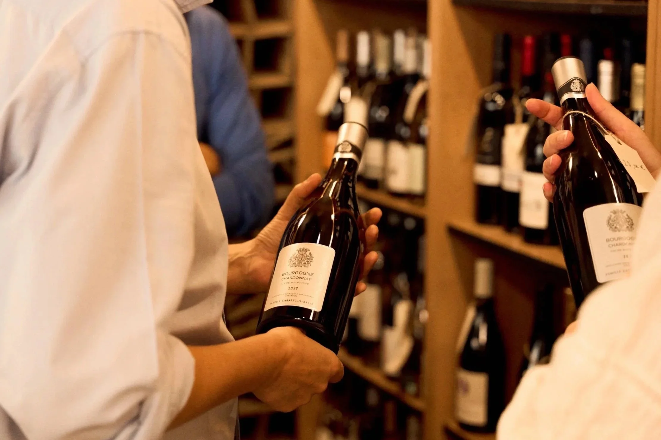 Burgundy wine bottles from Château de Pommard being presented in a Paris wine shop
