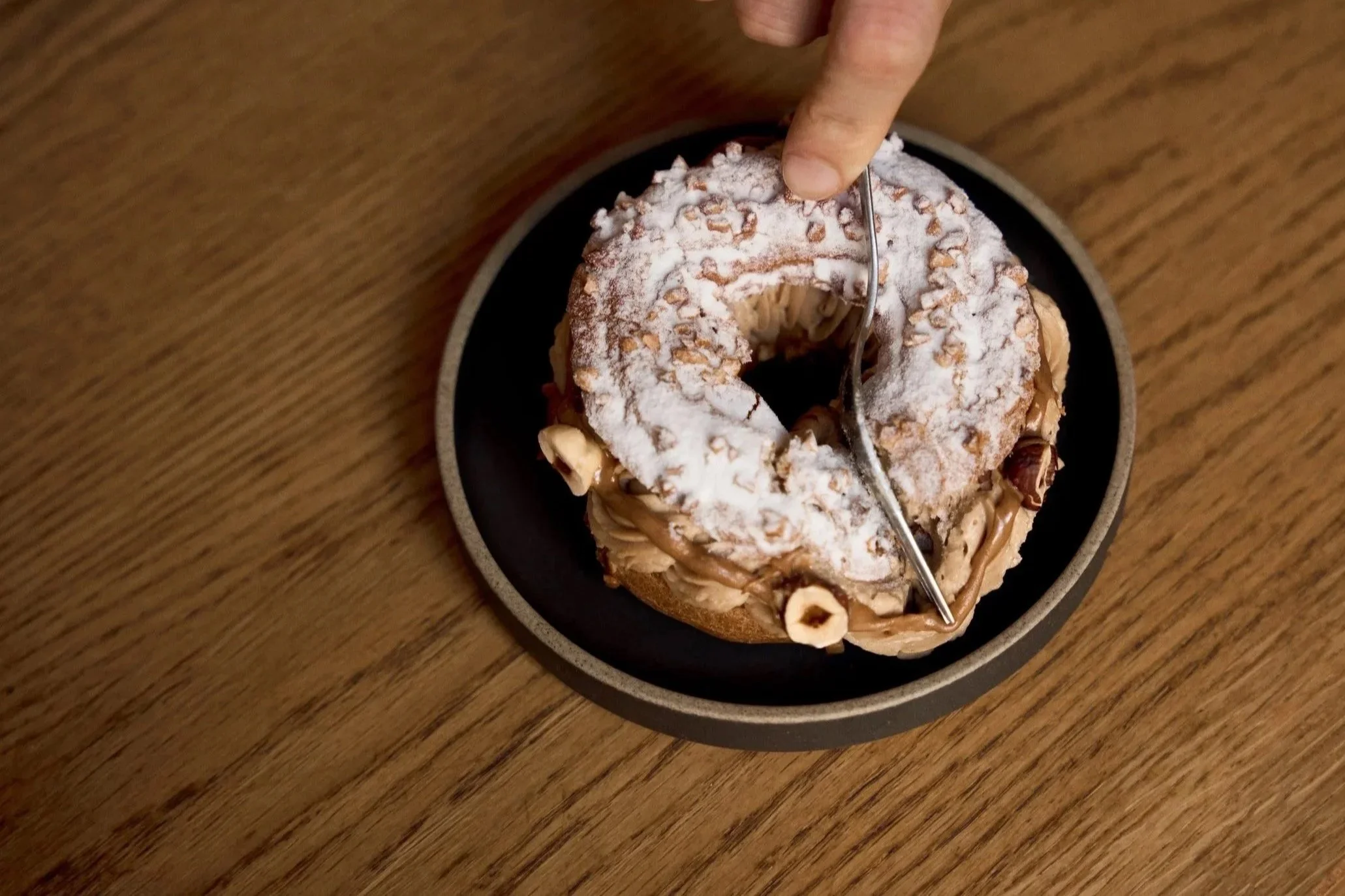 Paris-Brest pastry topped with hazelnuts and praline cream