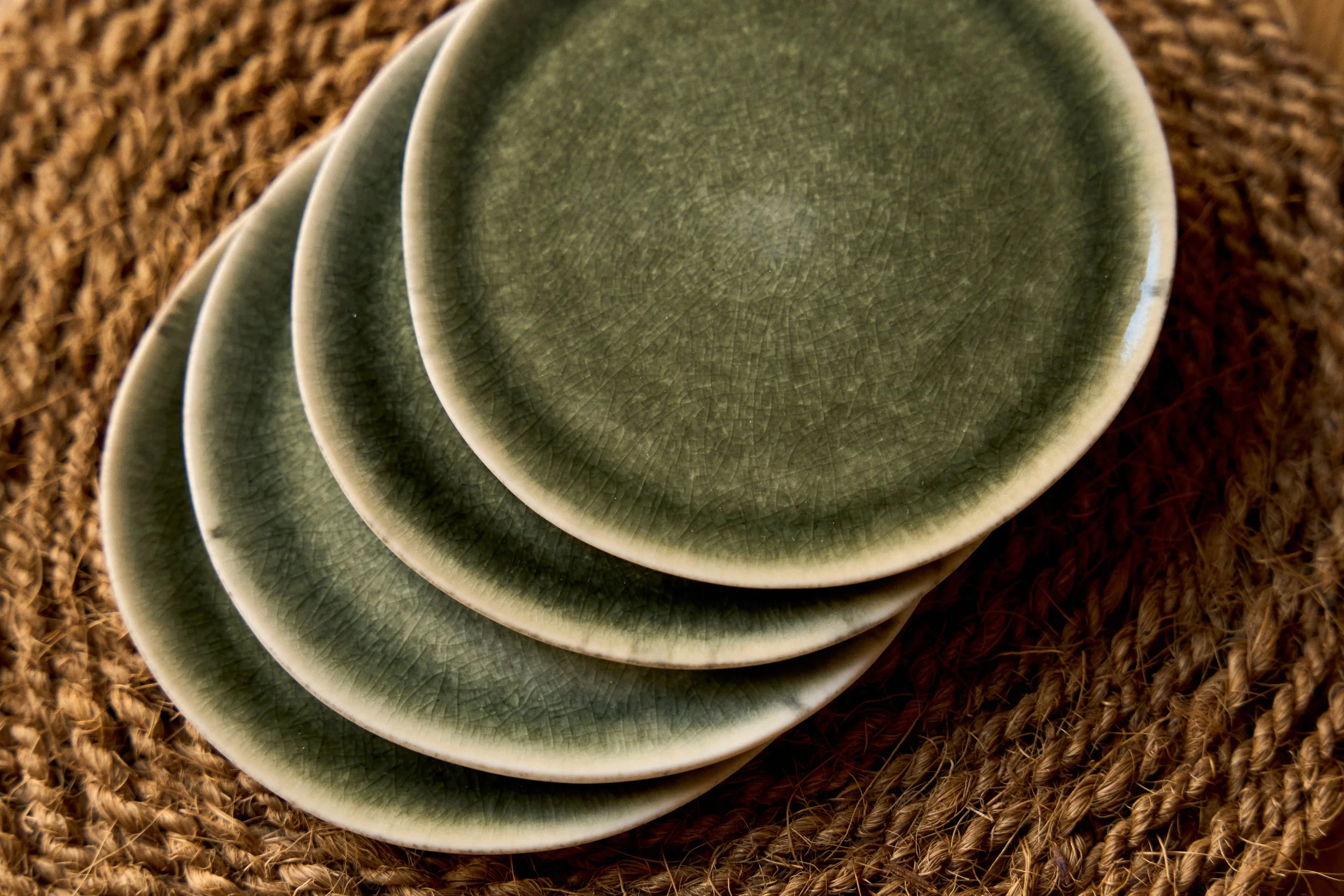 Stack of handmade green ceramic plates