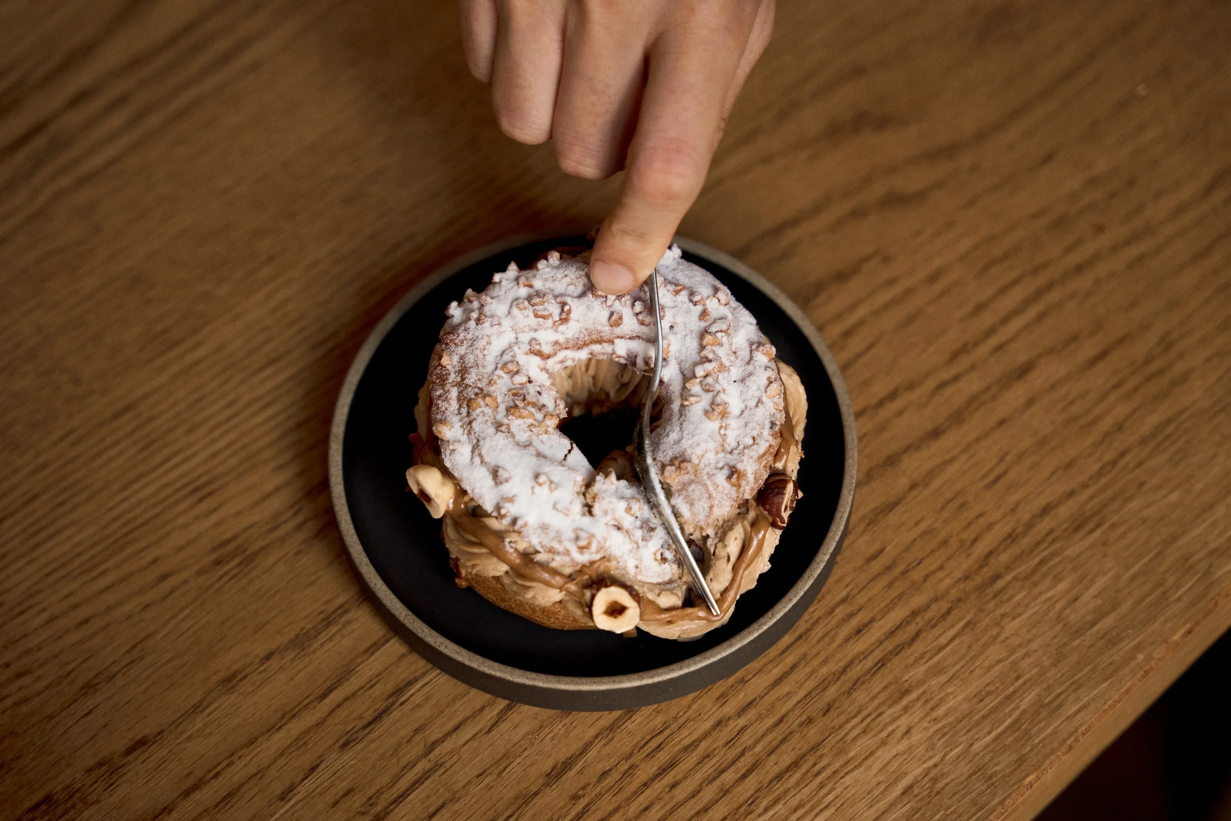Paris-Brest pastry topped with hazelnuts and praline cream