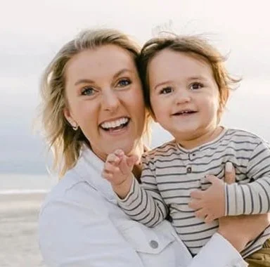 Jess with a child at the beach