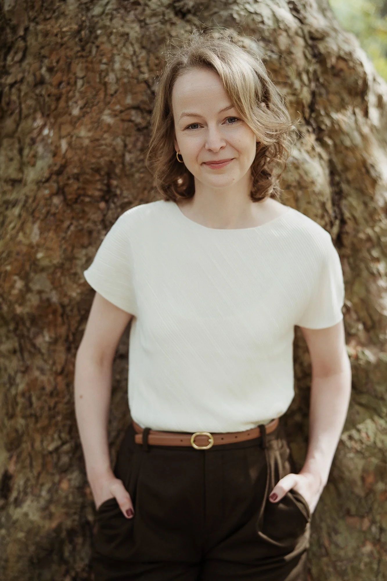 Professional headshot of published academic Katharina Gerhardt infront of a tree