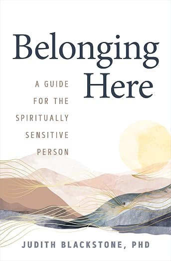 Book cover titled 'Belonging Here' by Judith Blackstone, PhD, with a subtitle 'A guide for the spiritually sensitive person,' featuring an abstract watercolor background with soft earthy tones and a pale sun.