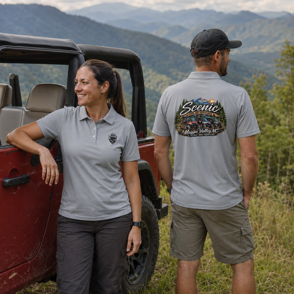 Two people, a woman and a man, standing outdoors near a red off-road vehicle, with a scenic mountain landscape in the background. The woman is leaning against the vehicle and smiling, while the man is facing away, looking at the scenery. Both are wearing gray shirts; the woman's shirt has a small logo, and the man's shirt has a large graphic on the back that says "Scenic Tours and Adventures, Maggie Valley, NC" with images of off-road vehicles and mountains.