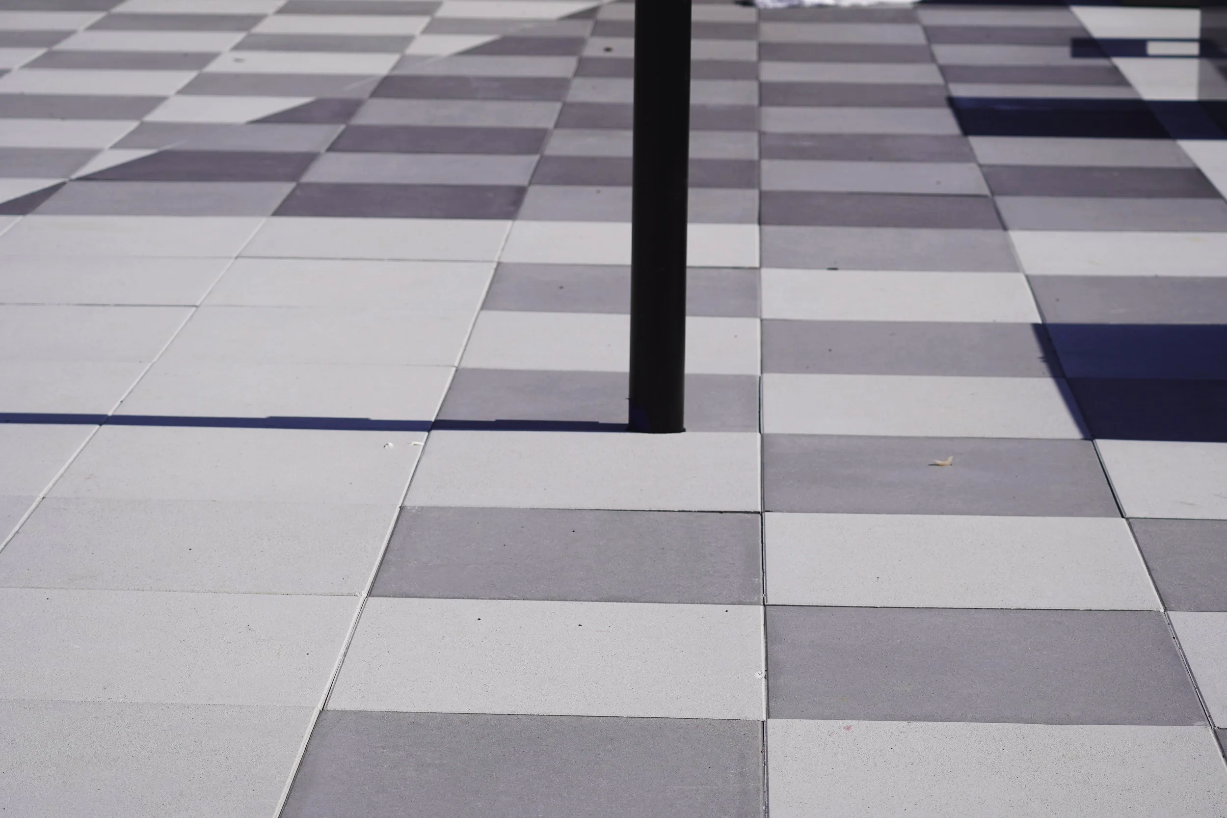 Checkered paver pattern on rooftop amenity deck at The Current apartment community, installed by 4G Paving