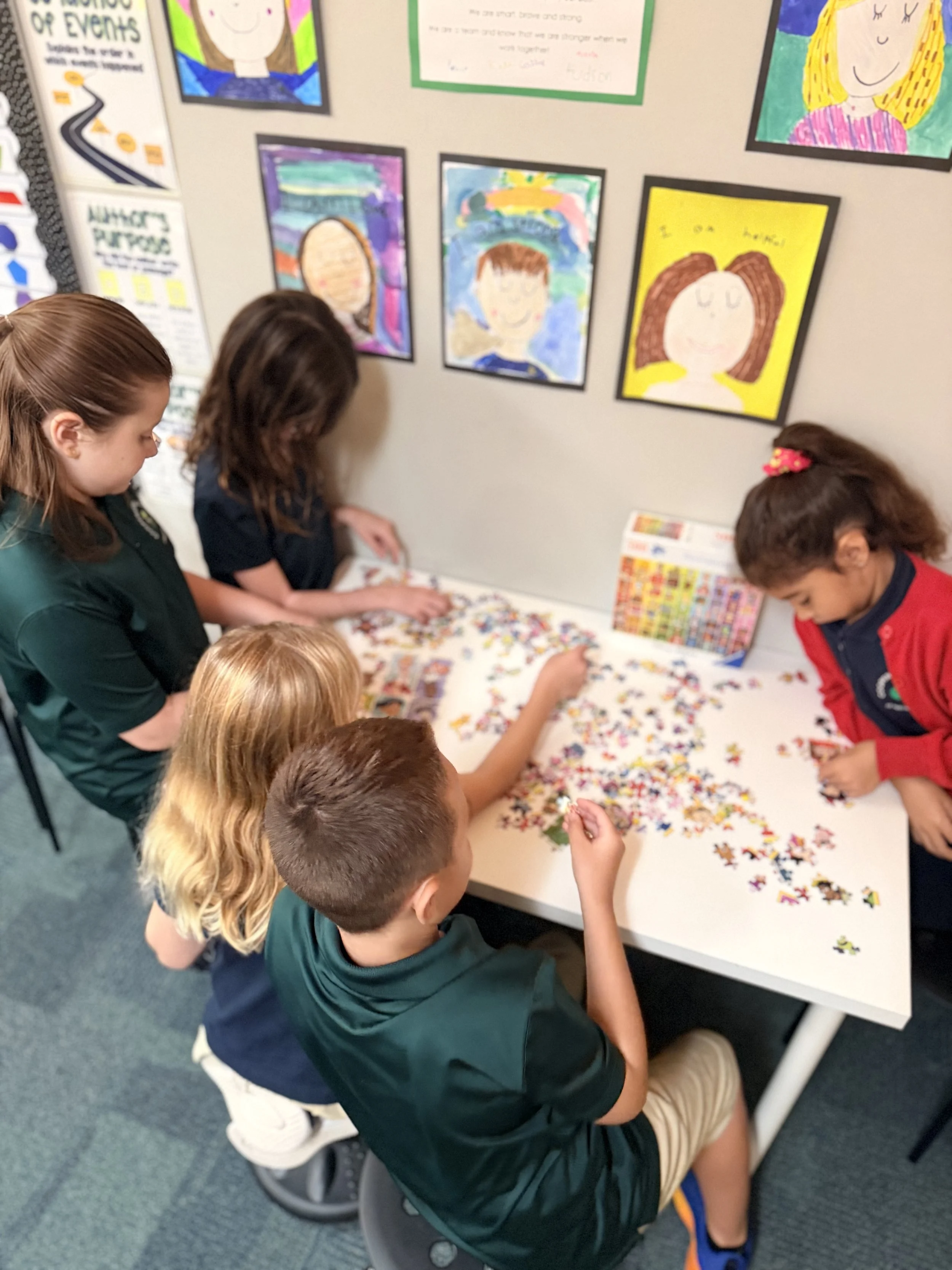 Grade school students working on a puzzle together in a small class at Cooperative School at Northland
