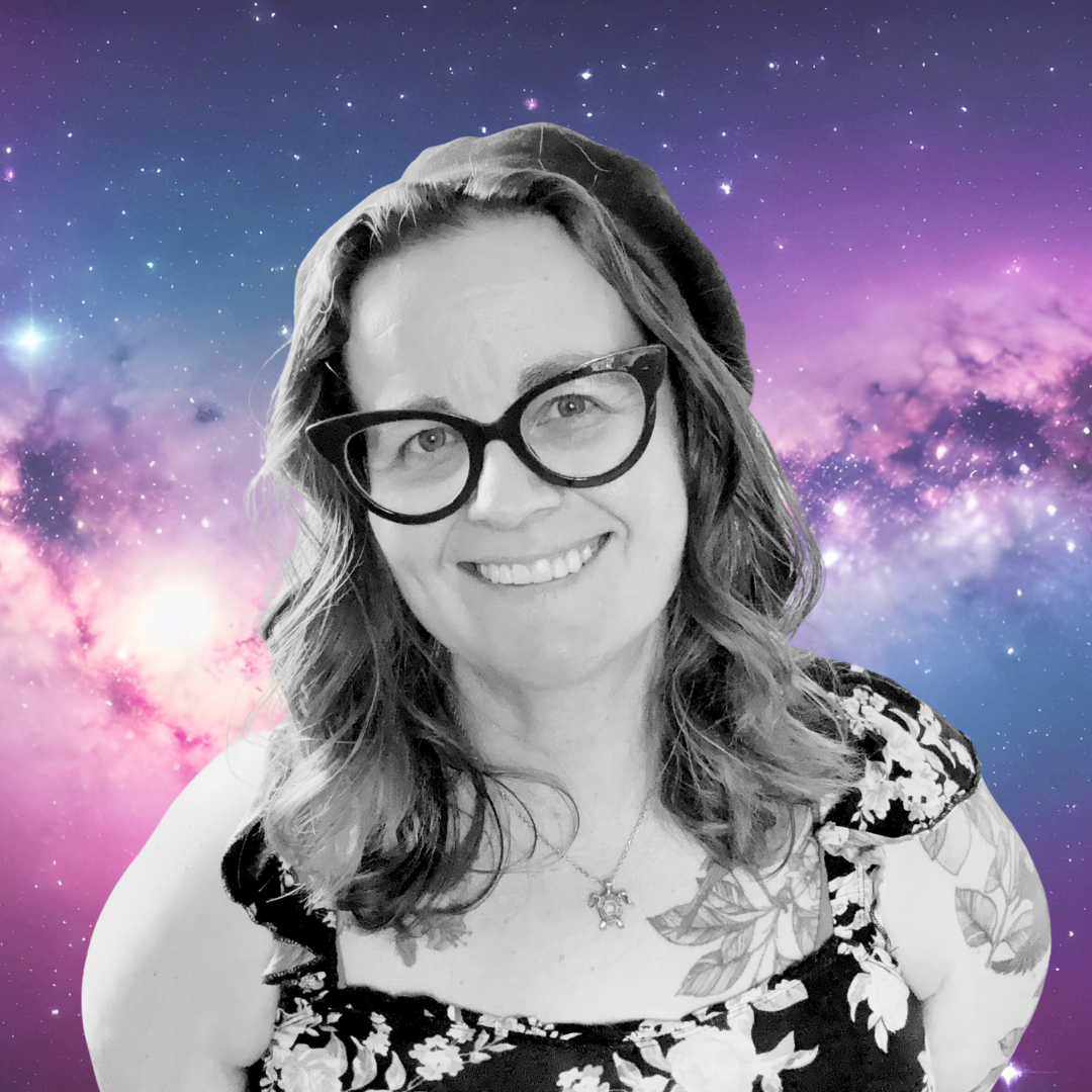 A smiling woman with wavy hair, wearing glasses, a floral dress, and a necklace, in front of a vibrant galaxy background.