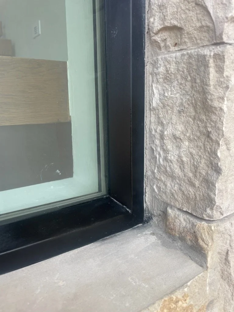 Close-up of a black vinyl window sill repaired.
