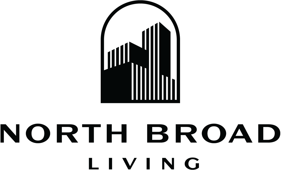 Logo for North Broad Living featuring a stylized image of buildings inside an arched shape.