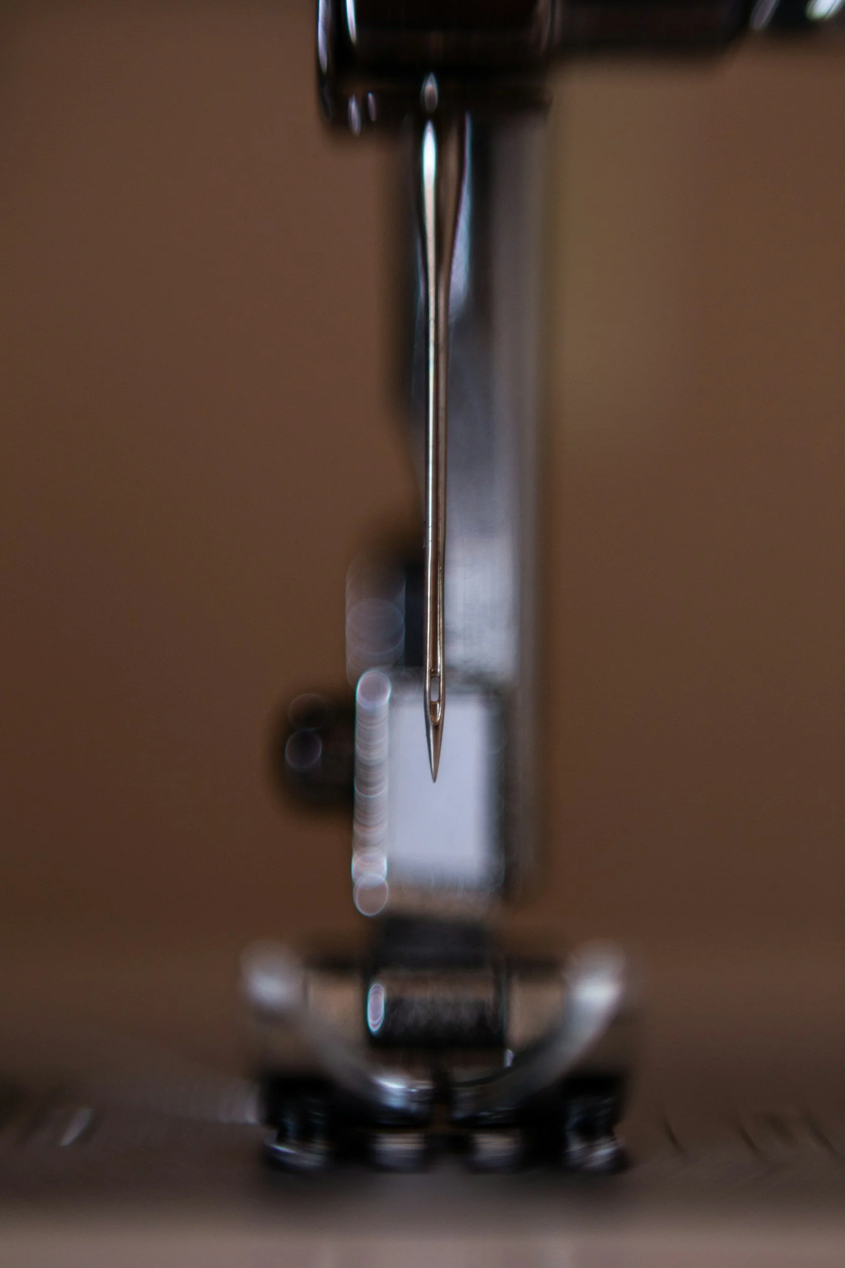 Close-up of a metallic vending machine coin slot and payment area with blurred background.