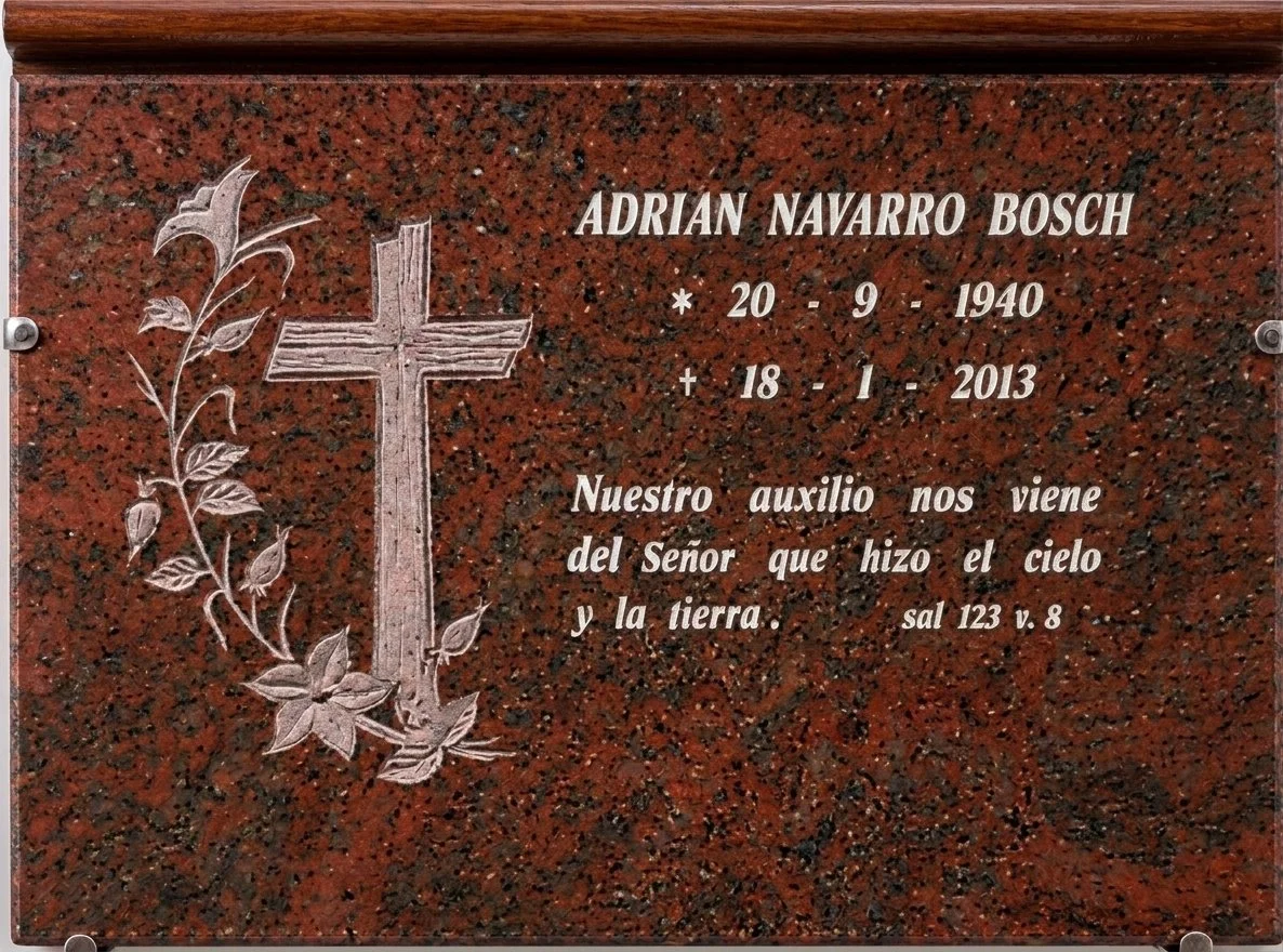 Lápida en granito rojo multicolor con un elegante bajorrelieve que dibuja una cruz y un delicado detalle floral. El contraste natural de la piedra con los motivos tallados aporta calidez y distinción a este diseño. Exclusiva obra de arte funerario el