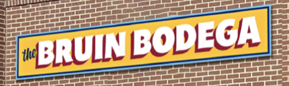 Sign for 'The Bruin Bodega' attached to a brick wall, with bold yellow, red, and white lettering.