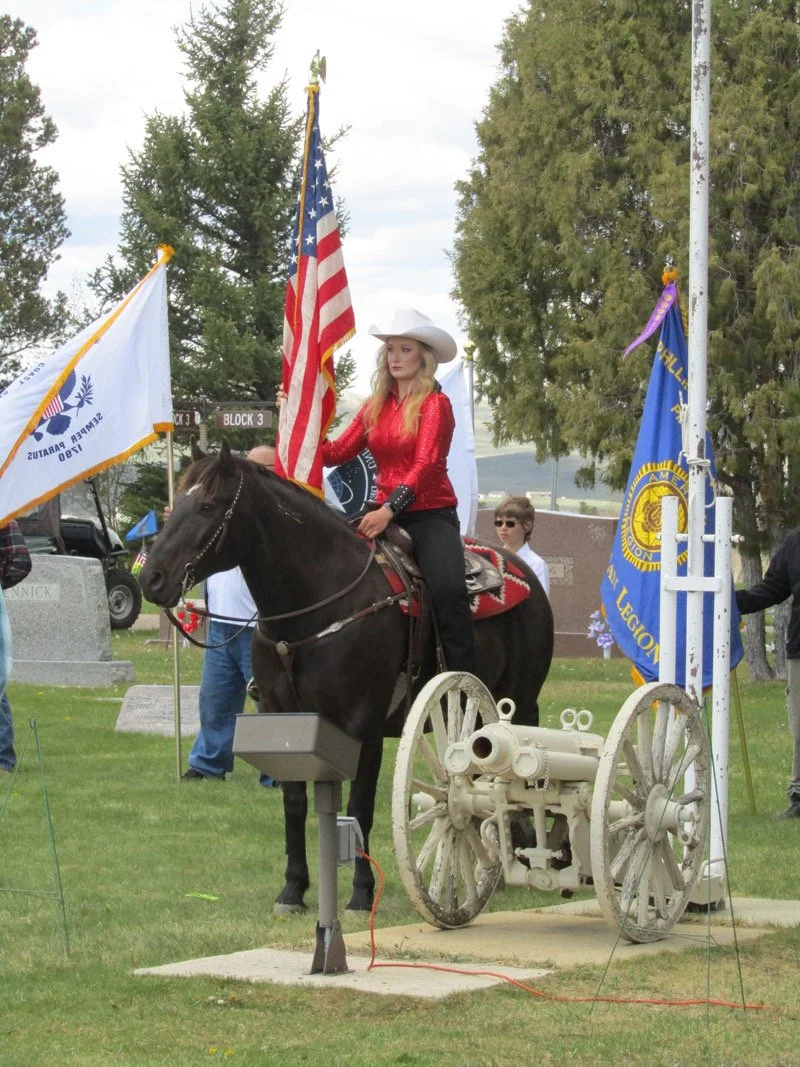 Mustang Phineas with American flag in cemetery for Memorial Day