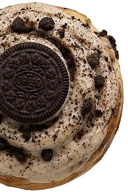 Close-up of an Oreo cookie topped with cookies and cream ice cream and chocolate cookie crumbs.