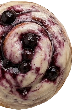Close-up of a blueberry swirl ice cream cone with blueberries on top.