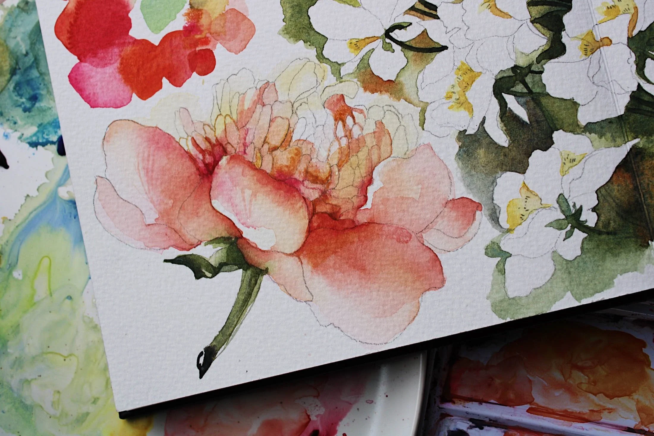 Watercolor painting of flowers with shades of pink, red, orange, white, yellow, and green.