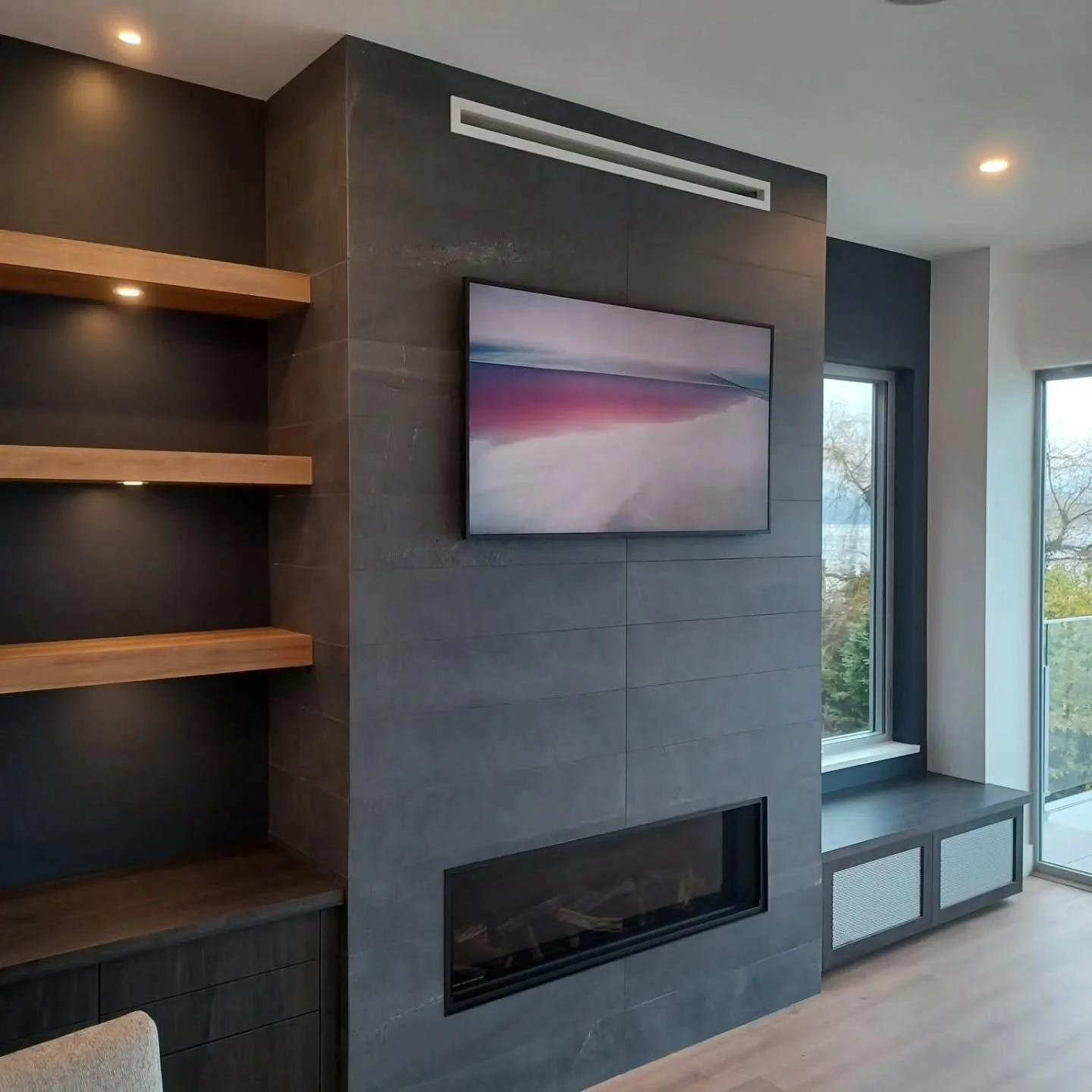 Tile deserves a spot in the living room too. 🔥

Charcoal tile wrapped around this fireplace brings a bold focal point to the space. Paired with the warm wood, it&rsquo;s a combination I&rsquo;d happily install again.

#BareHandsTile #SunshineCoastBC