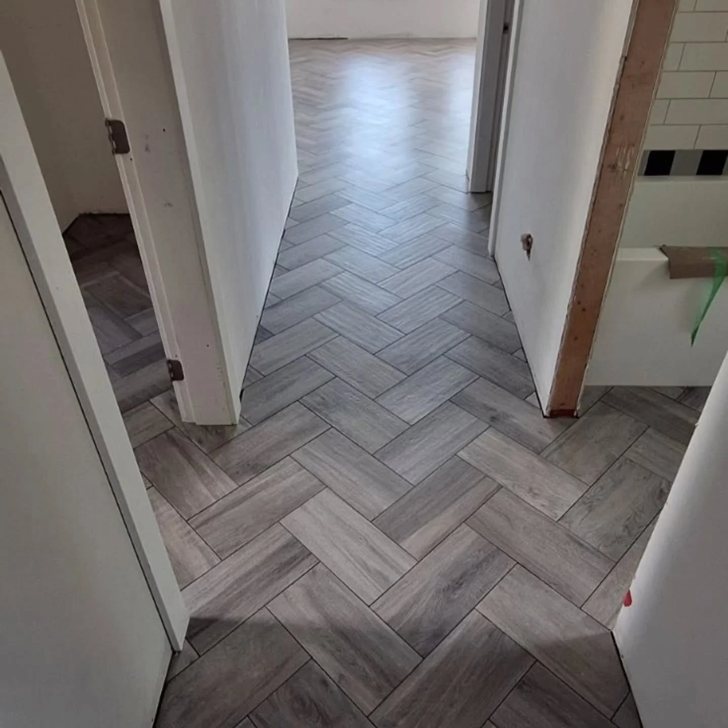 A classic pattern with a lot of movement.
Wood-look tile laid in herringbone, carried through the hallway and adjoining spaces for one continuous floor.
Layout matters. 👌
Bare Hands Tiling | Sunshine Coast, BC
Functional design. Built to last

#suns