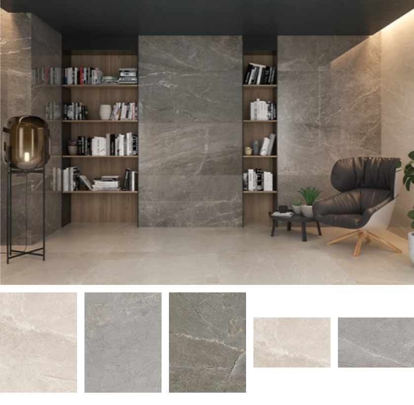 Modern living room with floor-to-ceiling gray stone wall, built-in wooden bookshelves filled with books, a black leather lounge chair with a small table and potted plants nearby, and ambient lighting.