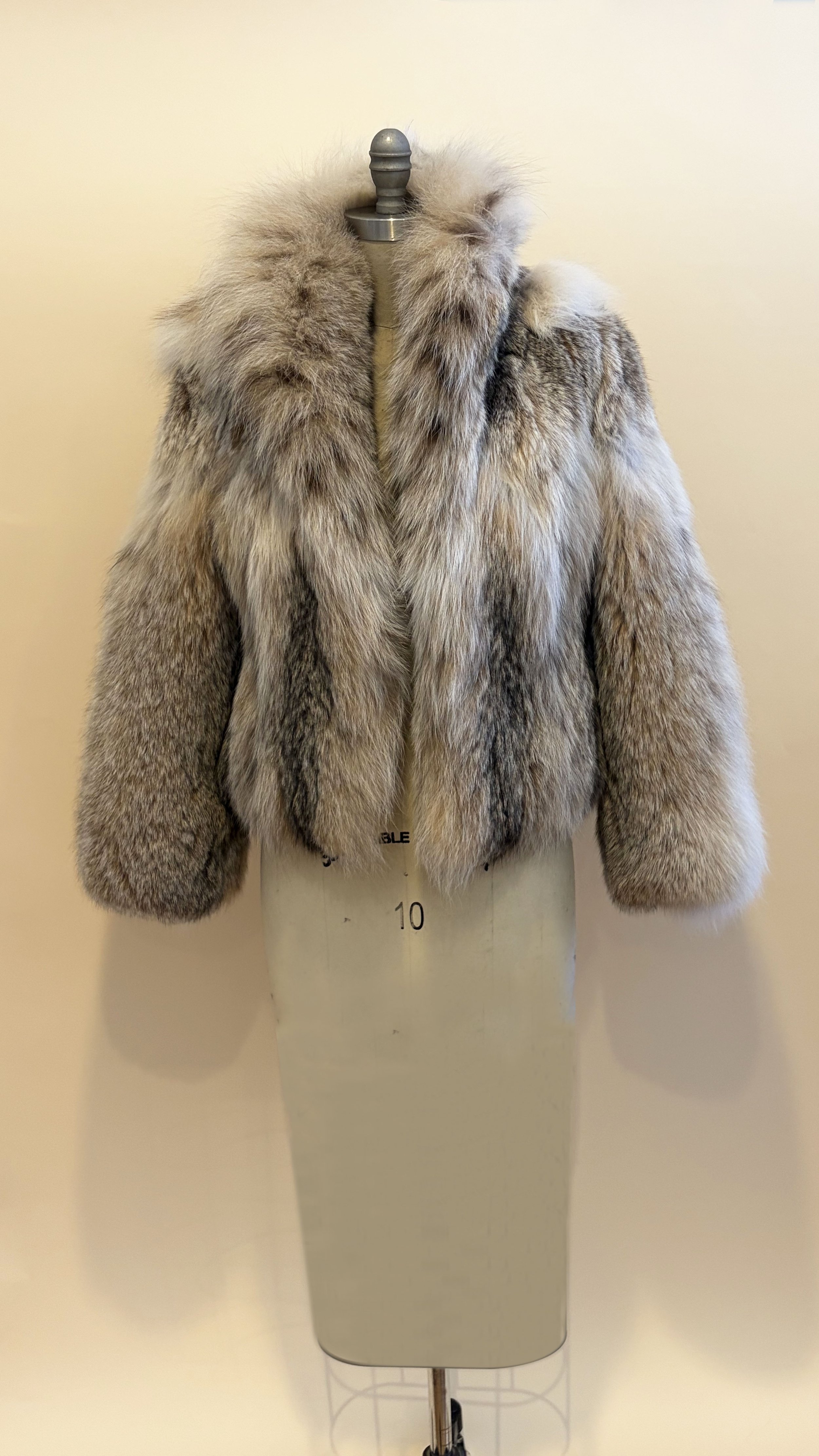grey fur coat on stand
