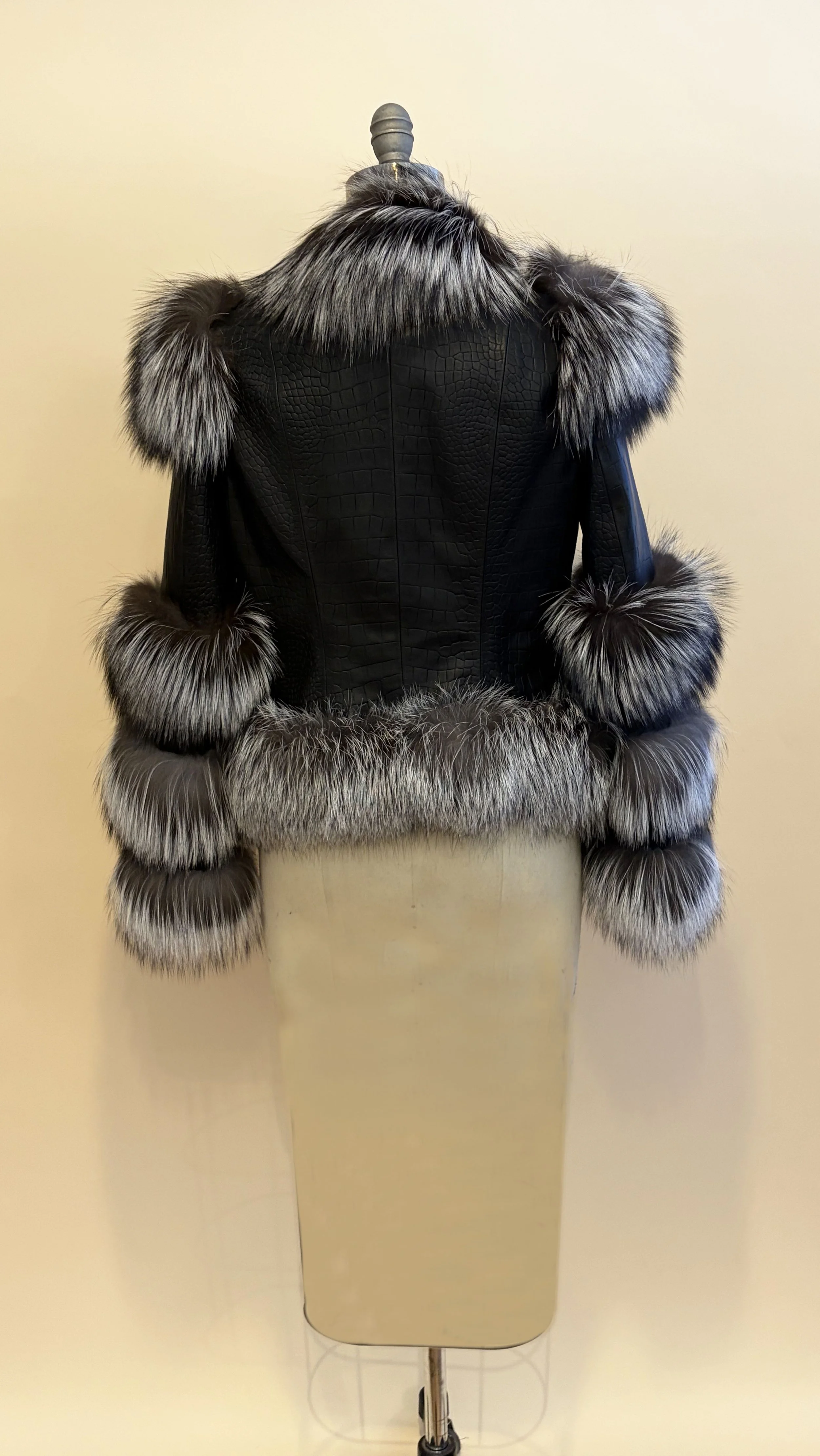 black fur coat on stand, back
