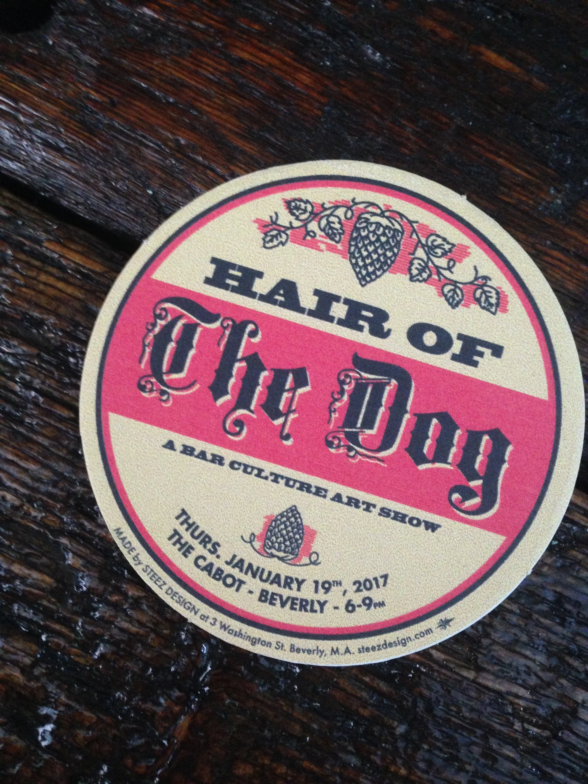 Close-up of a vintage-style circular event poster on a dark wooden table, featuring red and cream stripes, floral illustrations, and the words “Harvest Party.”