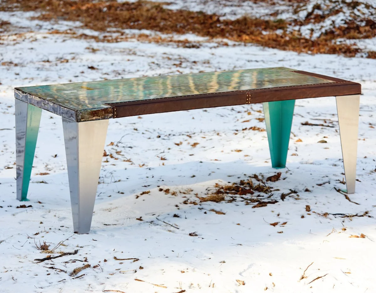 Colorful rectangular table with metallic legs standing in a snowy outdoor setting