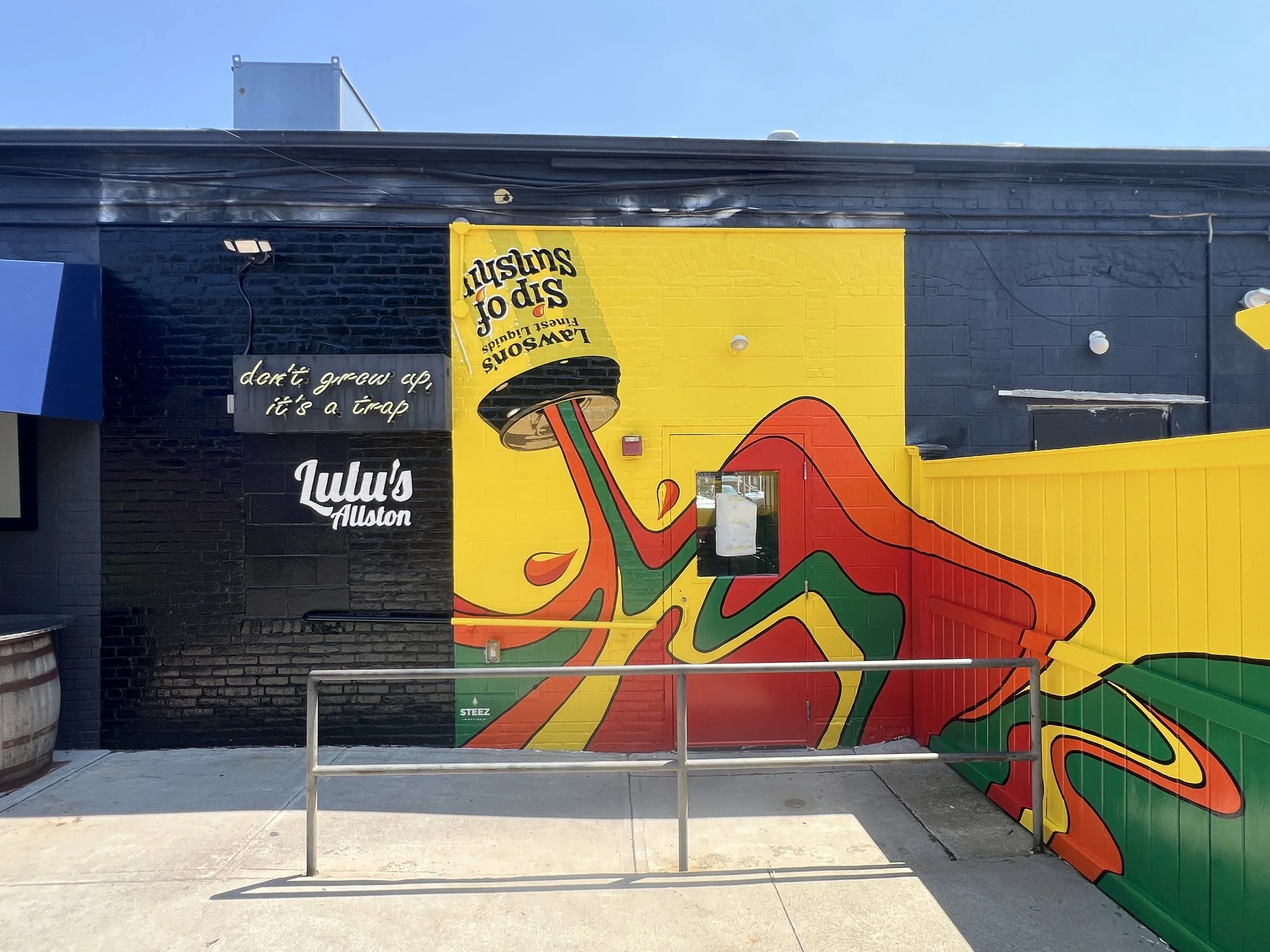 Colorful exterior mural at Lulu’s Allston restaurant featuring a giant red high-heeled shoe and text reading “Lulu’s Allston.”