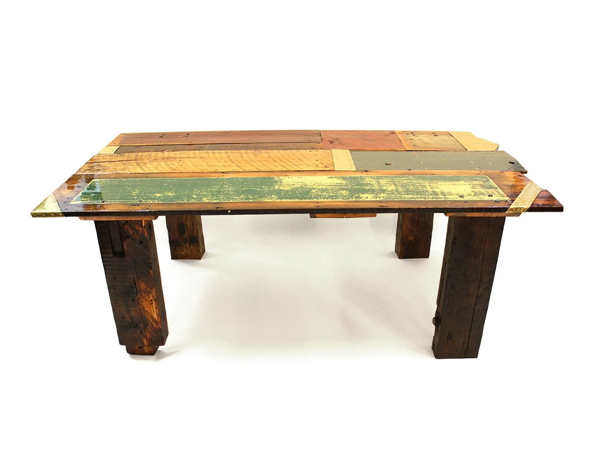 Rustic reclaimed wood dining table with multicolored plank tabletop and chunky legs