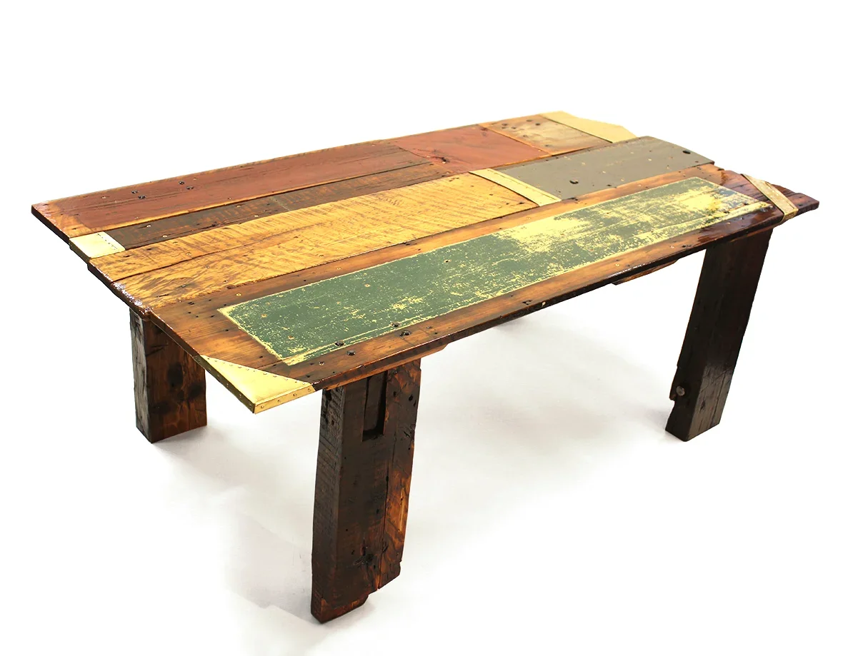 Rustic reclaimed wood coffee table with multicolored plank tabletop and sturdy wooden legs