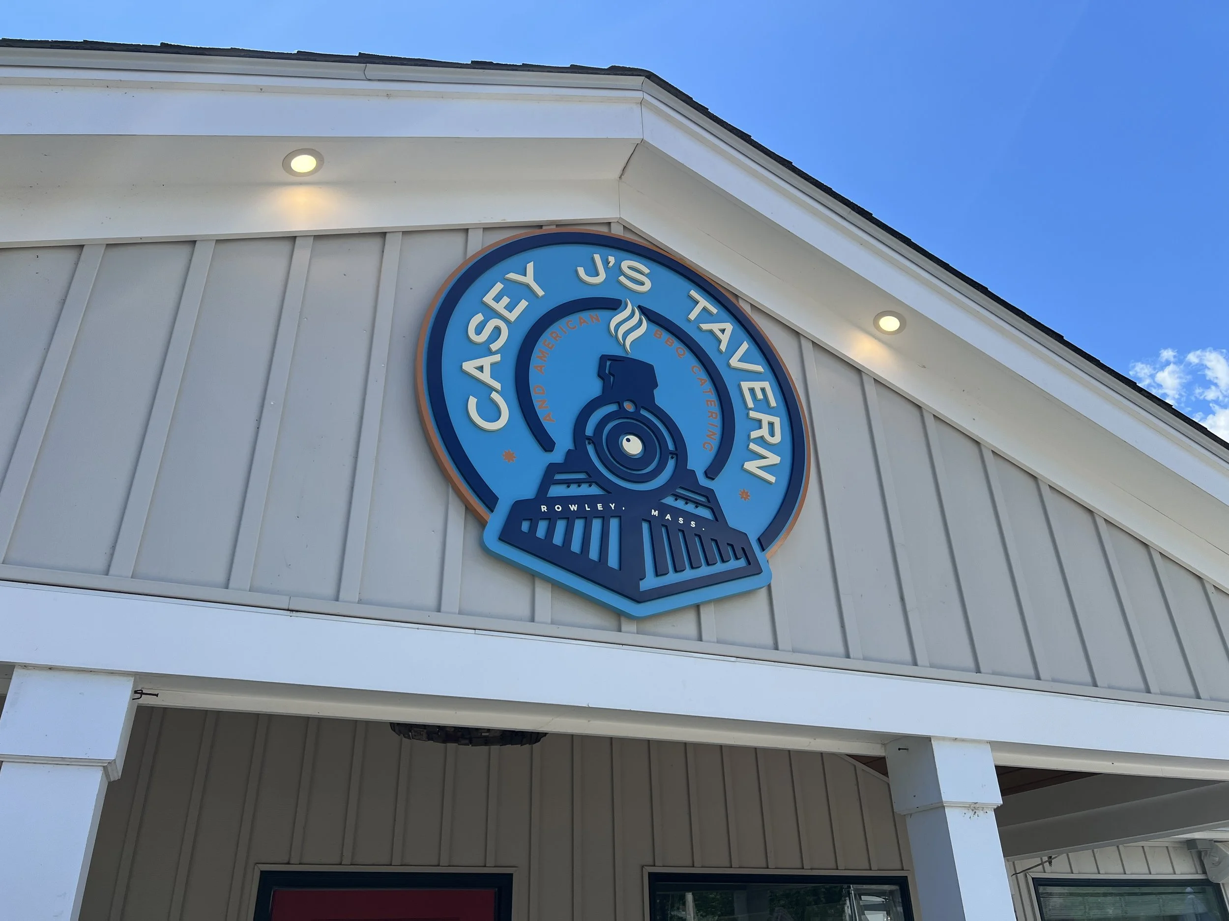 Exterior sign for Casey's Tavern American BBQ Catering in Rowley, Massachusetts.