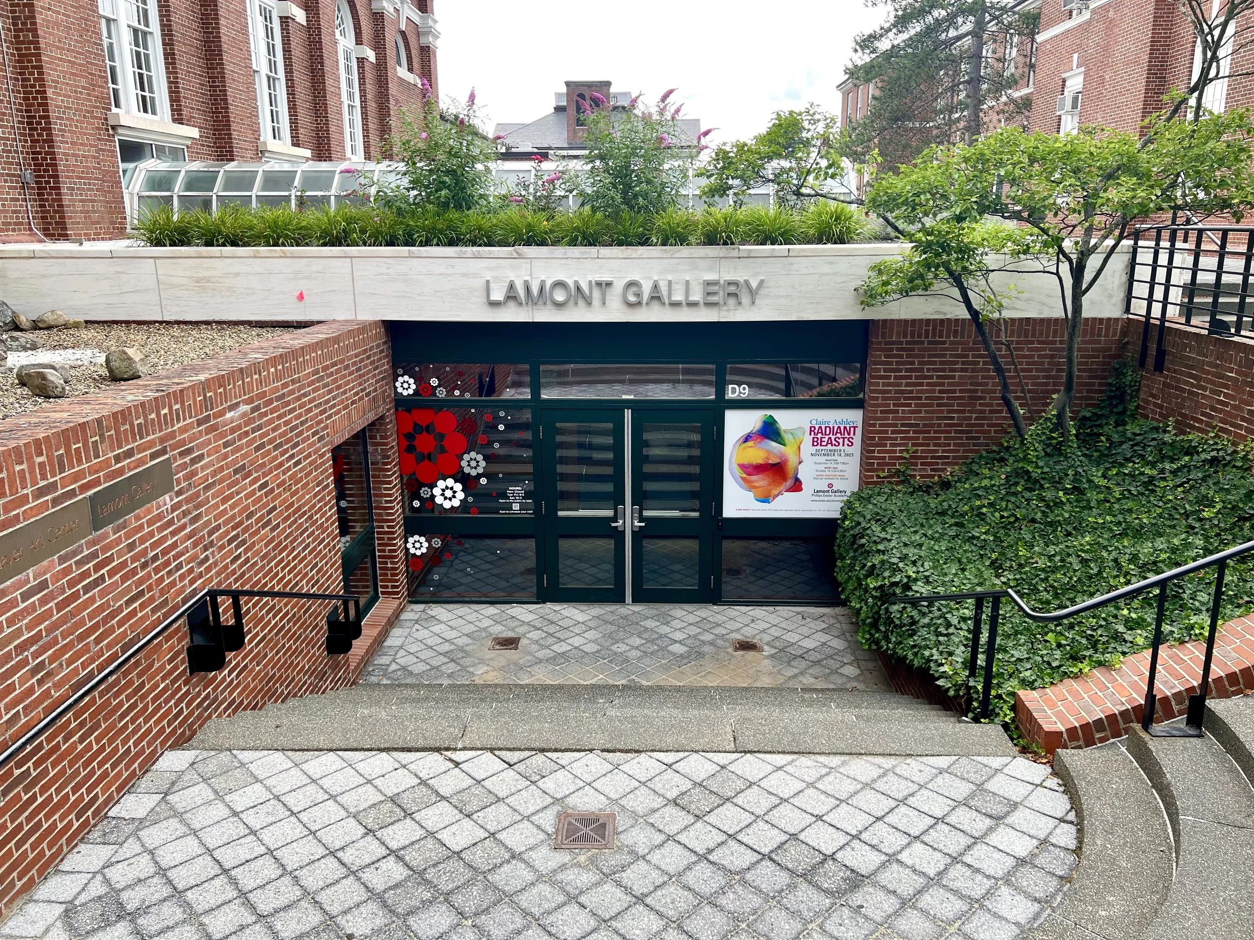 Entrance to Lamont Gallery in a brick building, surrounded by landscaped planters and stairs.