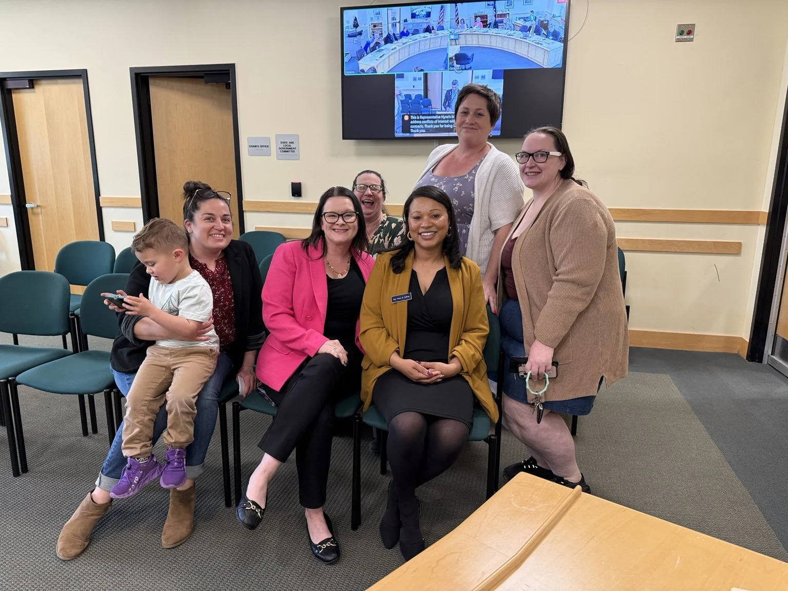 Rep. Flavia DeBrito with Parent Ambassadors and a young child celebrating the passage of LD 1566