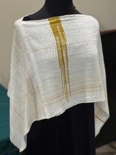 White garment with yellow vertical stripe detail displayed on a mannequin