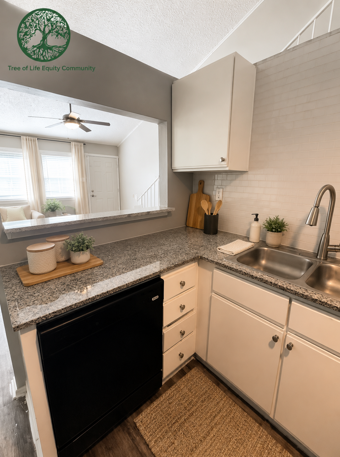 Bright, modern kitchen with updated countertops, white cabinetry, and an open view into the living area.