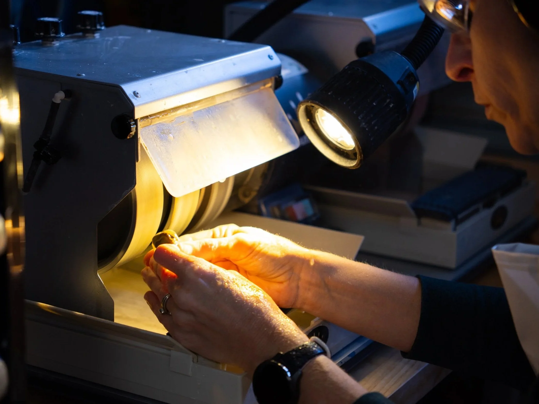 A scientist examining samples under a microscope in a laboratory setting.