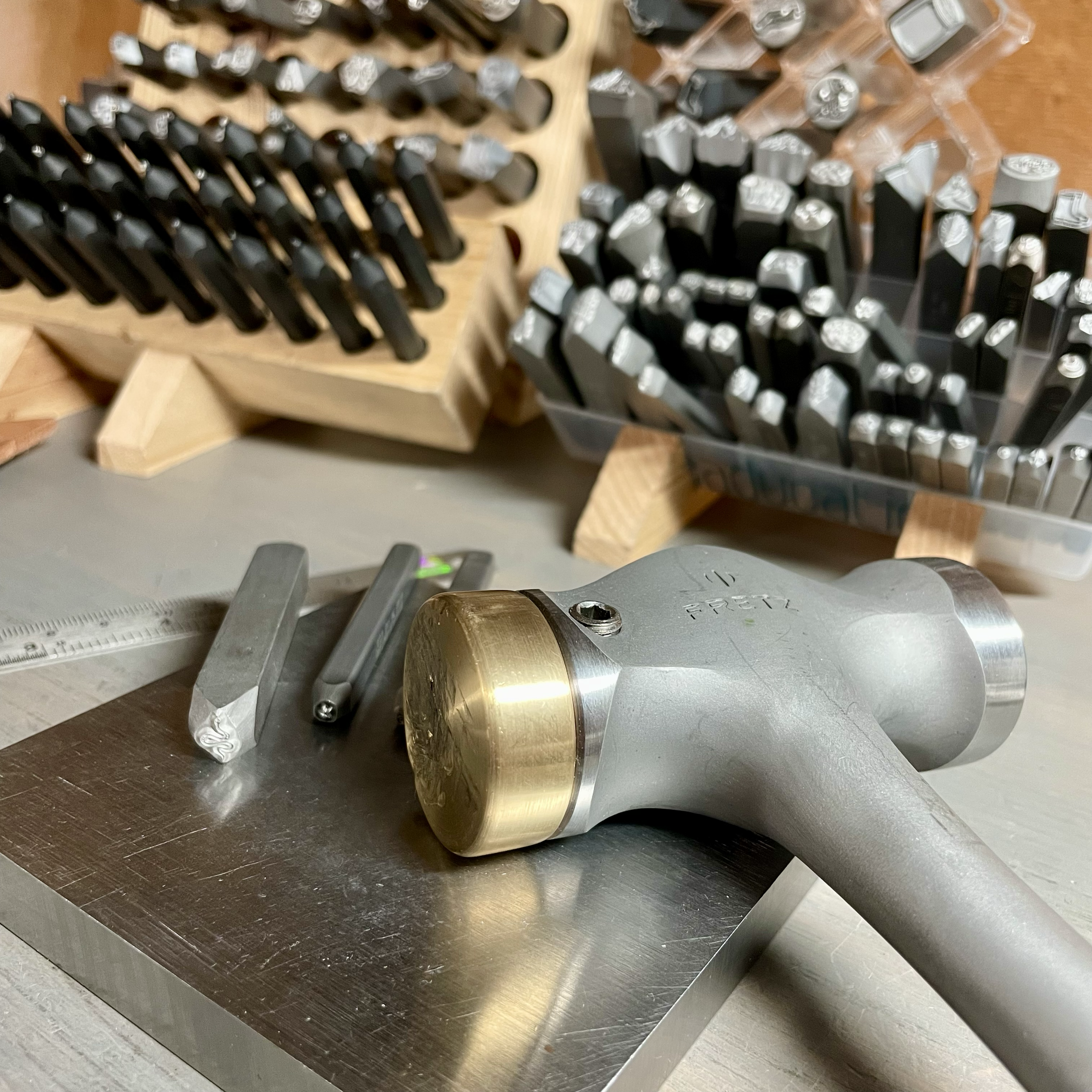 Close-up of various metal weights and tools on a wooden and metal surface.