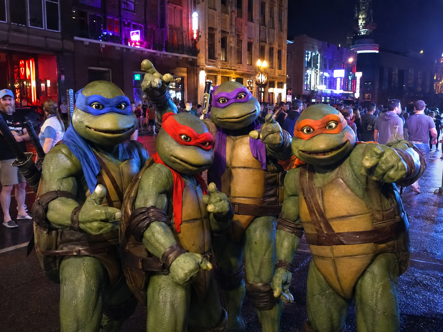 Illustration of four movie-style Ninja Turtles on a neon-lit downtown Nashville street