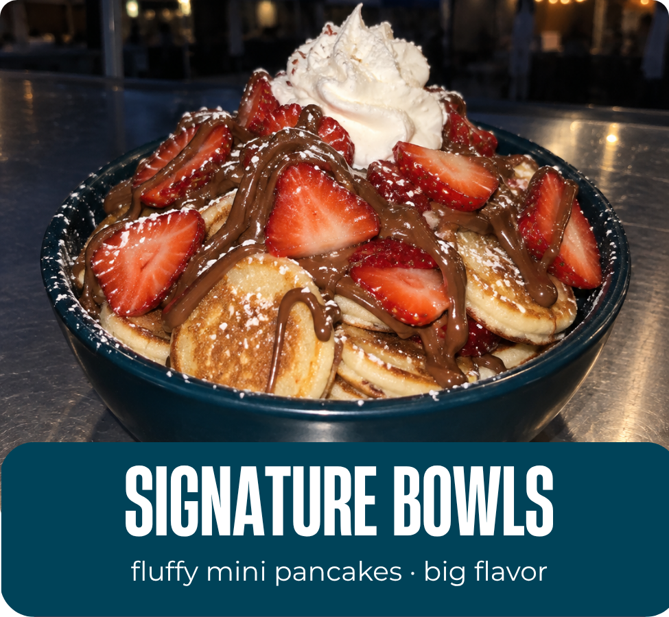 TideHaus signature mini pancake bowl with strawberries, whipped cream, powdered sugar and chocolate drizzle.