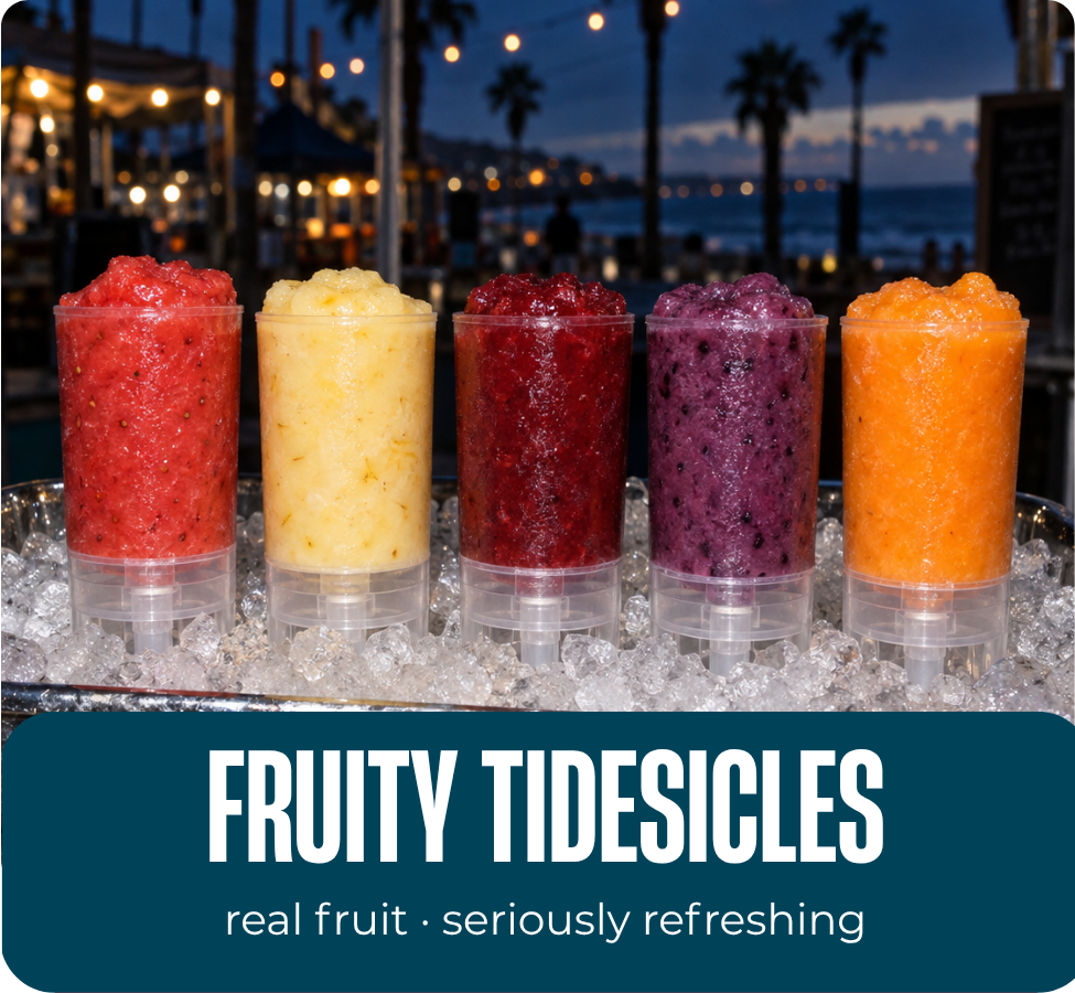 Five blended fruit Tidesicles in clear push-pop tubes displayed over ice by the waterfront.