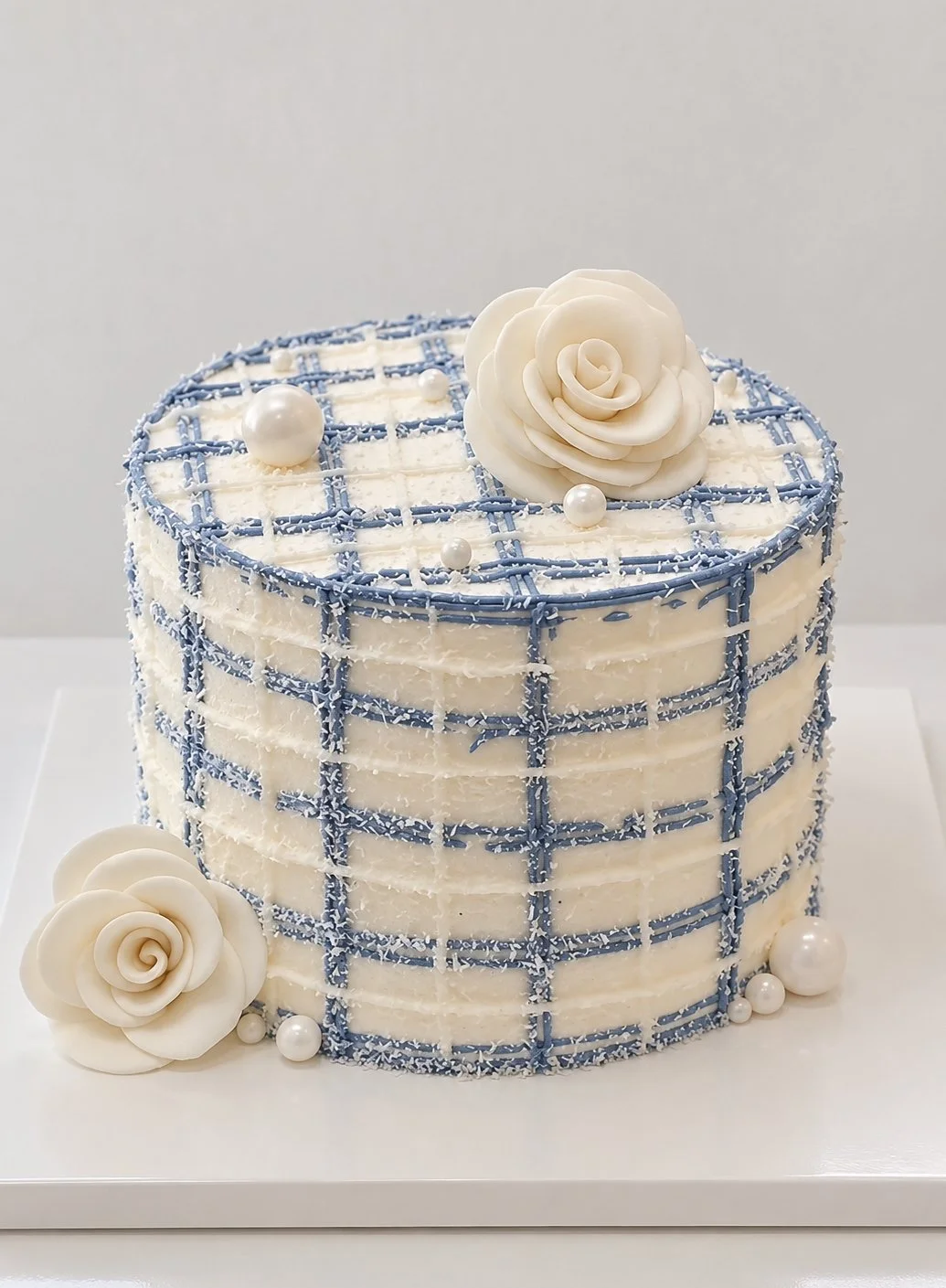Light fresh cream custom cake with elegant plaid design and floral details by J. Atelier Cake in Lehi, Utah