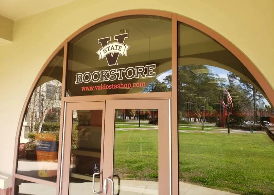 'Valdosta State Bookstore' and displays website www.valdostashop.com Exterior Window Graphics Created by Custom Graphics Georgia North Metro Atlanta Sign Installation and Service
