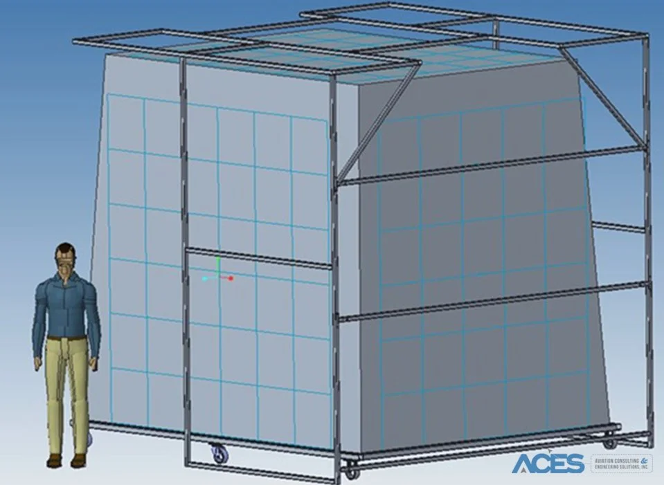 3D CAD rendering of a large aircraft cargo fire containment cover test enclosure, showing a metal support frame, paneled walls, and a human figure for scale.
