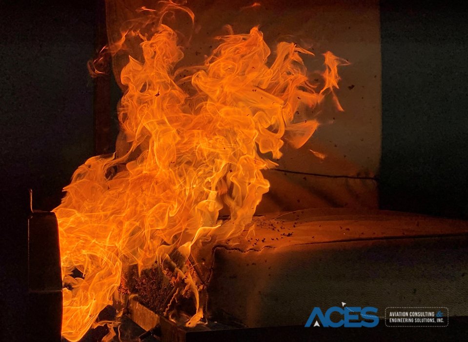 Aircraft seat cushion undergoing oil burner fireblock testing at ACES