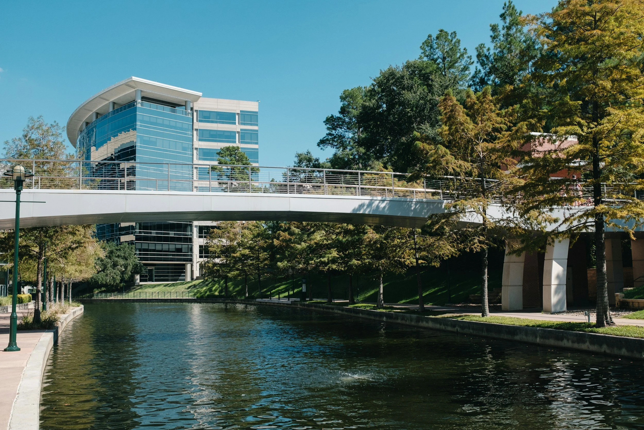 The Woodlands Waterway with bridge and buildings in The Woodlands Texas, betrayal trauma therapy available to The Woodlands residents via telehealth