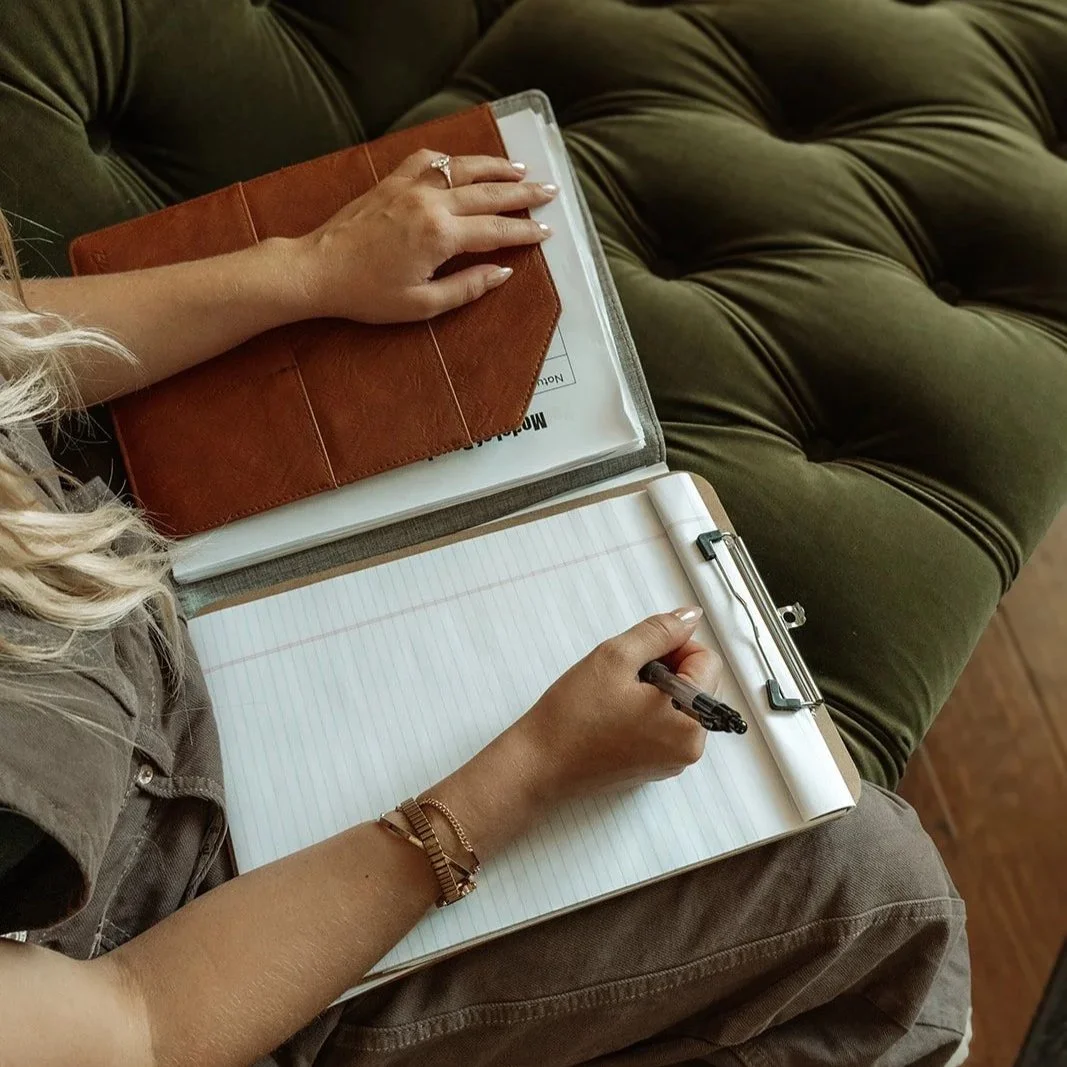 Therapist writing in binder, Accelerated Resolution Therapy practice Scottsdale Arizona