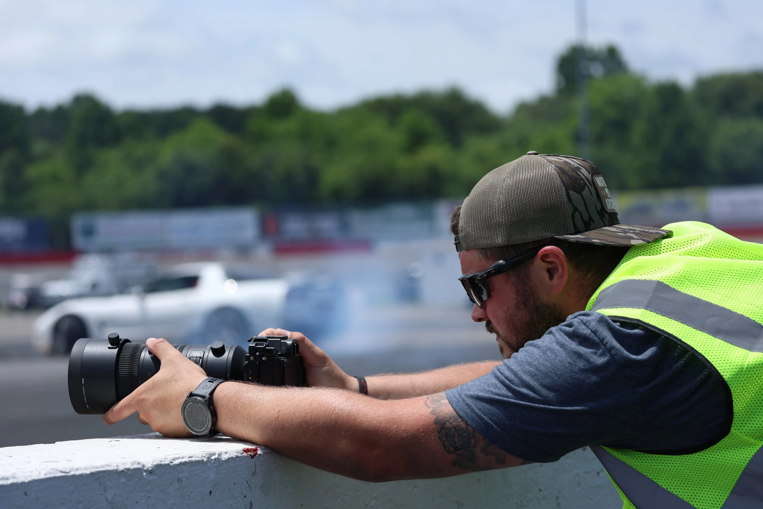 Hurley Media photographer capturing motorsports action at a track.