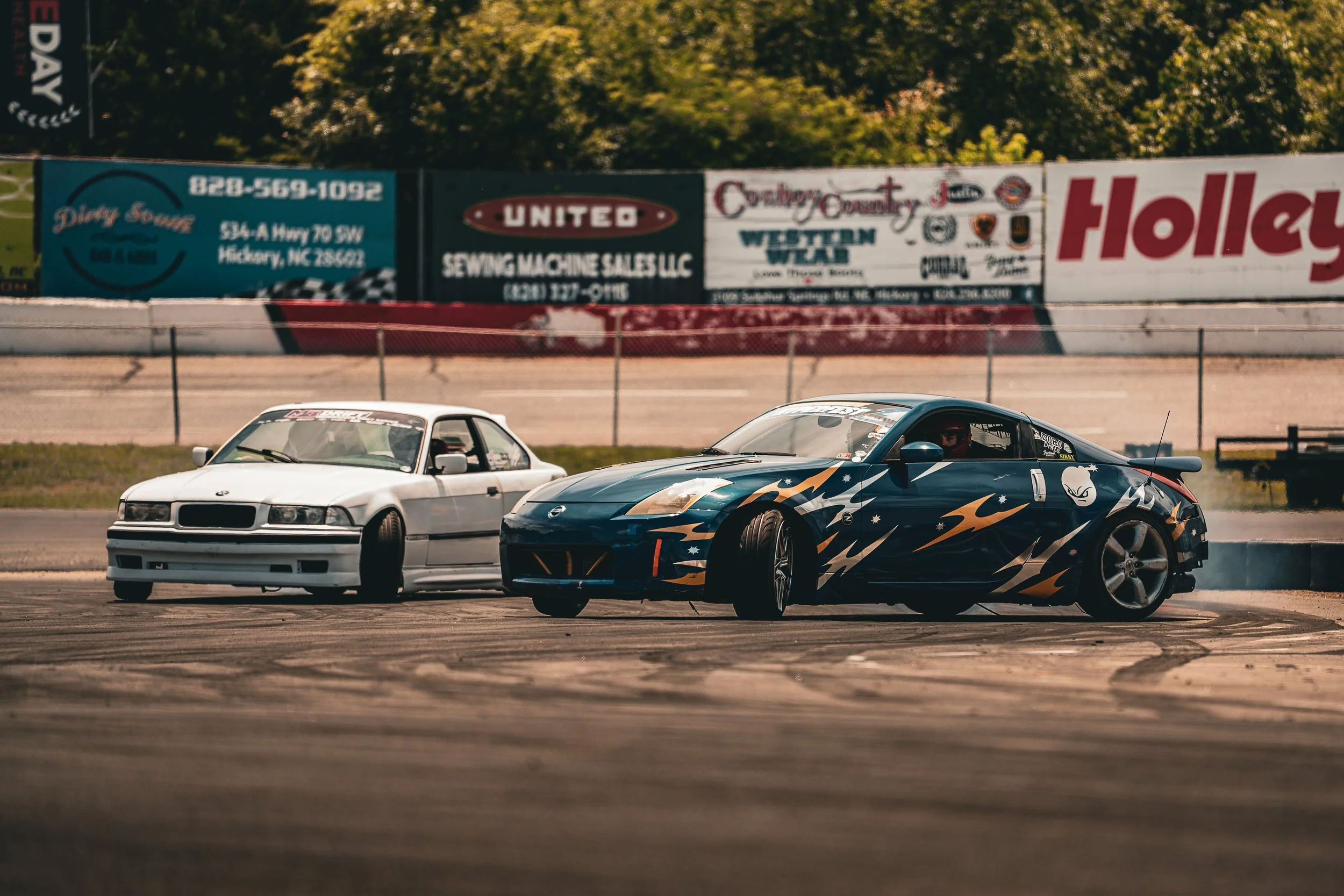 Two drift cars competing on a track photographed by Hurley Media.