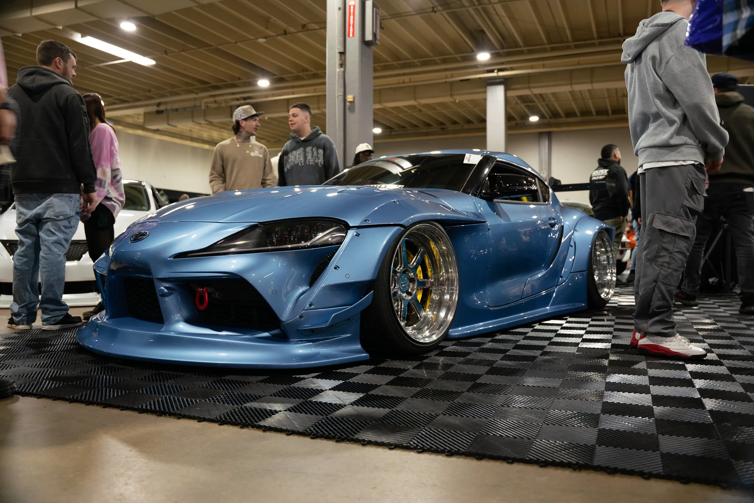 Blue Supra on display at an automotive event.