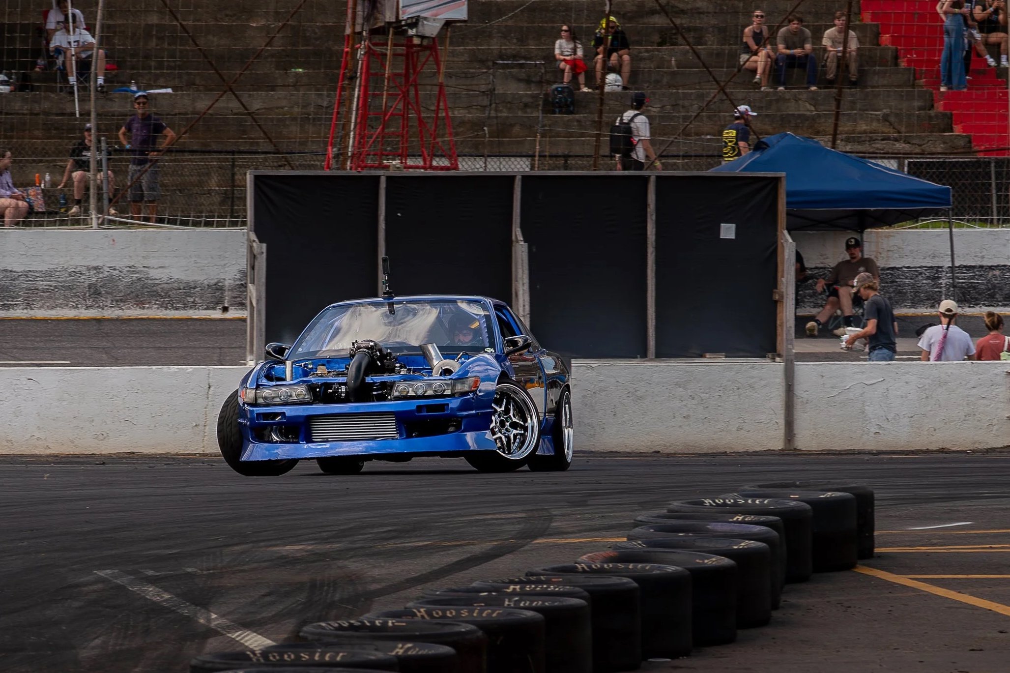 Blue drift car competing on track.